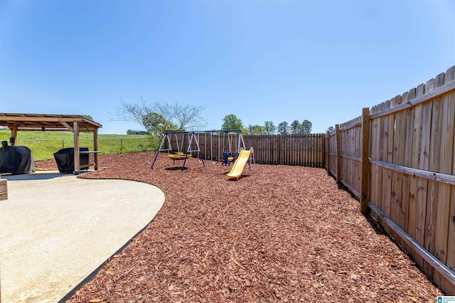 view of yard with a fenced backyard and a playground