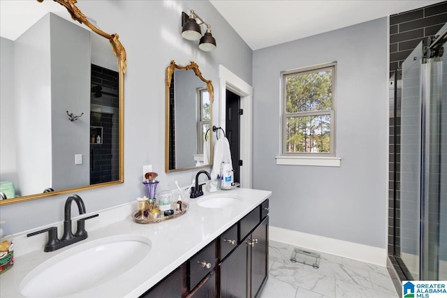 full bath with marble finish floor, a sink, double vanity, and a tile shower