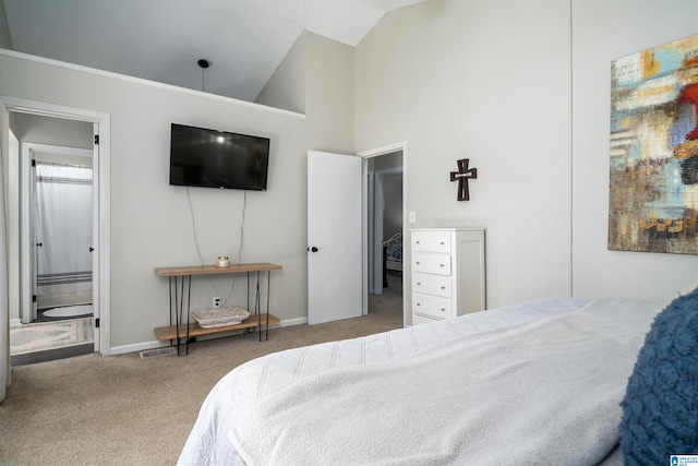 carpeted bedroom featuring high vaulted ceiling, baseboards, ensuite bathroom, and visible vents