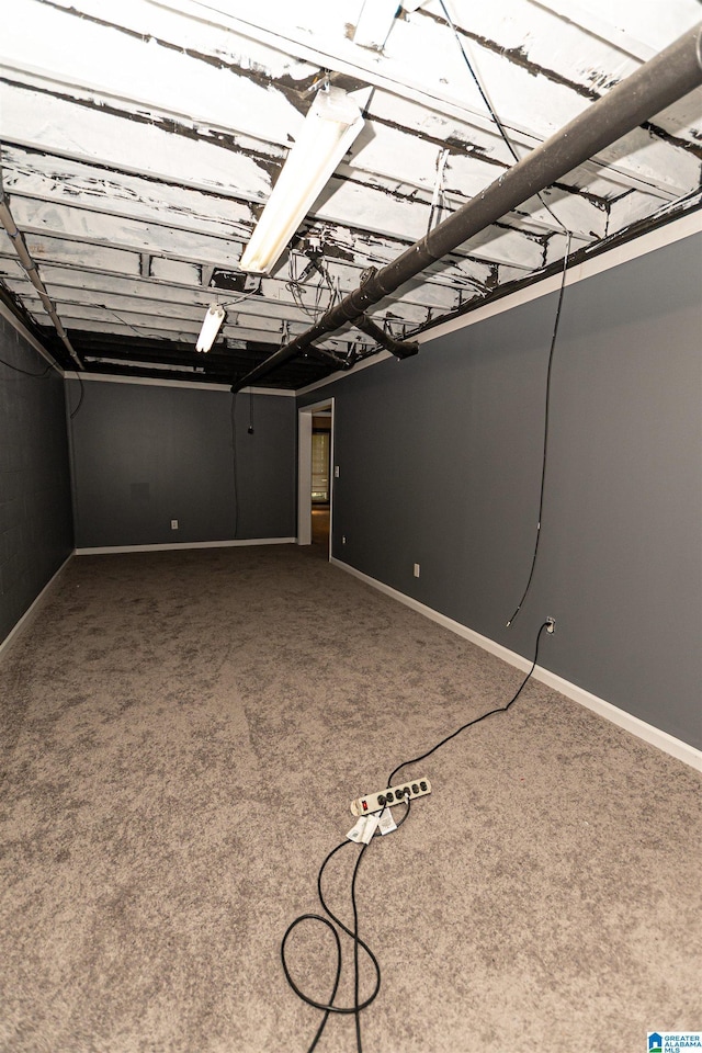 basement featuring baseboards and carpet
