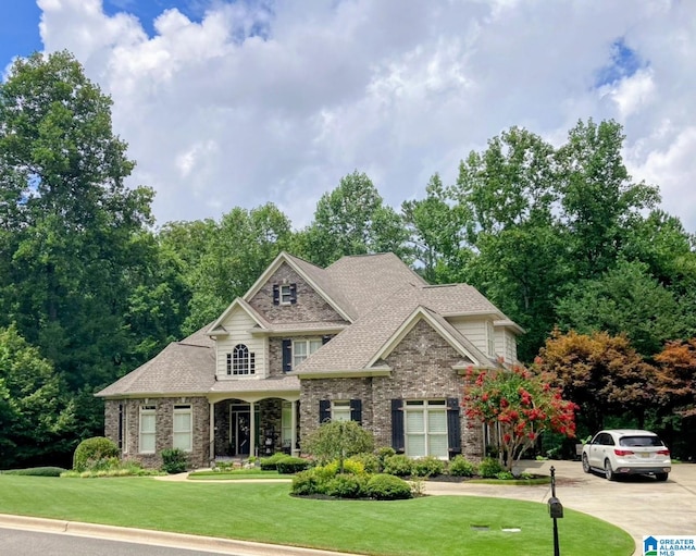 1065 Saint Andrews Pkwy, Oneonta, AL 35121 - view of front facade featuring brick siding, roof with shingles, and a front lawn