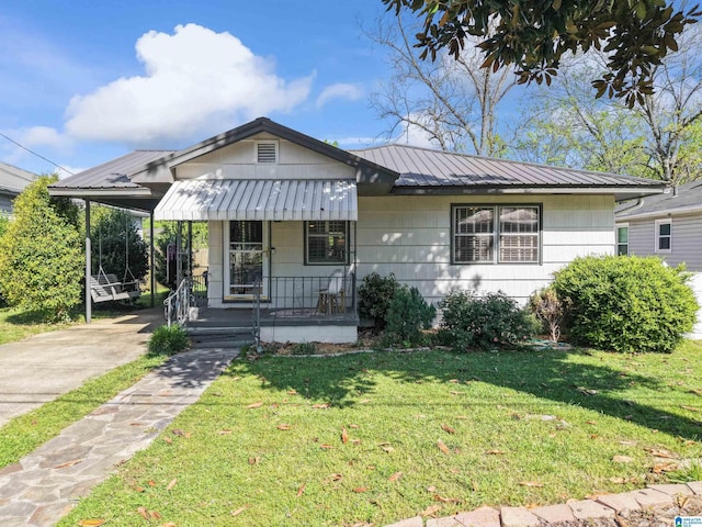 2110 S 4th Ave, Irondale, AL 35210 - bungalow-style home featuring a carport, metal roof, a front yard, and driveway