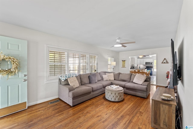 2110 S 4th Ave, Irondale, AL 35210 - living area with wood finished floors, baseboards, a ceiling fan, and visible vents