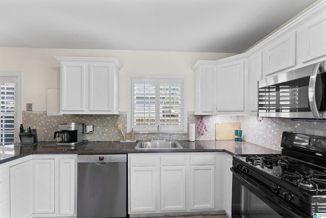 2110 S 4th Ave, Irondale, AL 35210 - kitchen with a sink, tasteful backsplash, white cabinets, and appliances with stainless steel finishes