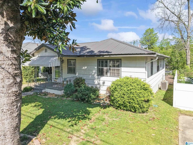 2110 S 4th Ave, Irondale, AL 35210 - view of front facade featuring central air condition unit, metal roof, a front yard, and a porch