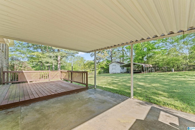 view of patio featuring a deck and an outdoor structure