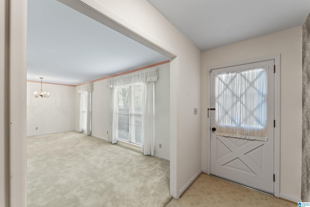 entryway with baseboards, a notable chandelier, and light carpet