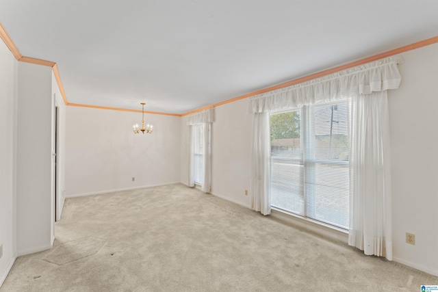 unfurnished room featuring crown molding, baseboards, an inviting chandelier, and light carpet
