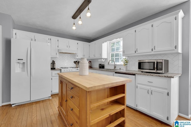 913 Falling Star Ln, Alabaster, AL 35007 - kitchen featuring tasteful backsplash, wooden counters, under cabinet range hood, white appliances, and white cabinetry
