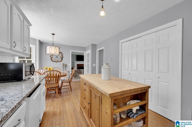 913 Falling Star Ln, Alabaster, AL 35007 - kitchen with white cabinets, light wood finished floors, white dishwasher, butcher block counters, and decorative light fixtures
