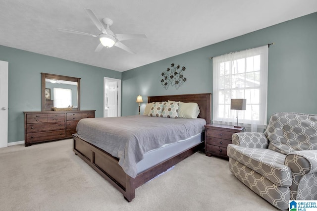 913 Falling Star Ln, Alabaster, AL 35007 - bedroom featuring multiple windows, ensuite bath, a ceiling fan, and light carpet