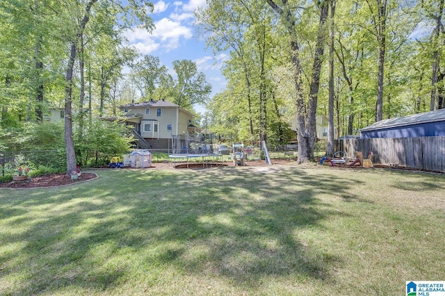 913 Falling Star Ln, Alabaster, AL 35007 - view of yard featuring a trampoline, a playground, and fence