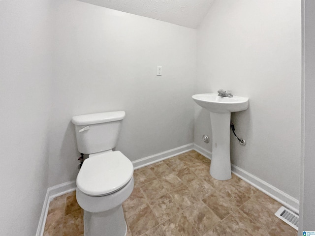 3 Holt Ave, Birmingham, AL 35214 - bathroom with visible vents, baseboards, a sink, and toilet