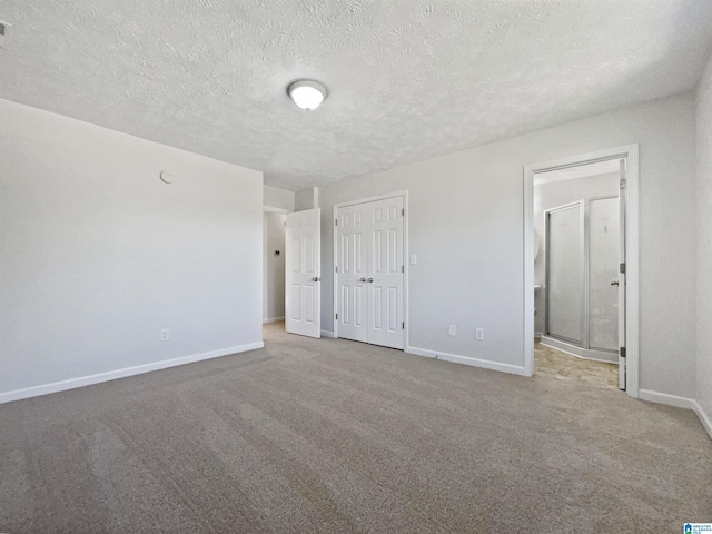 3 Holt Ave, Birmingham, AL 35214 - unfurnished bedroom with ensuite bathroom, baseboards, a closet, carpet, and a textured ceiling