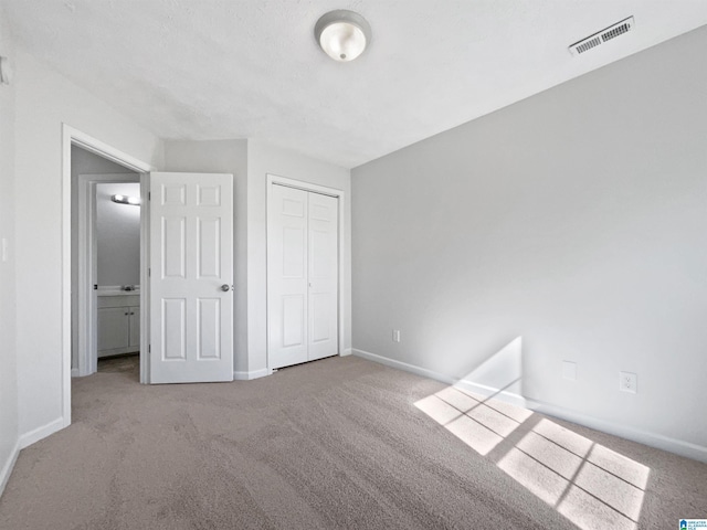 3 Holt Ave, Birmingham, AL 35214 - unfurnished bedroom featuring a closet, carpet, visible vents, and baseboards