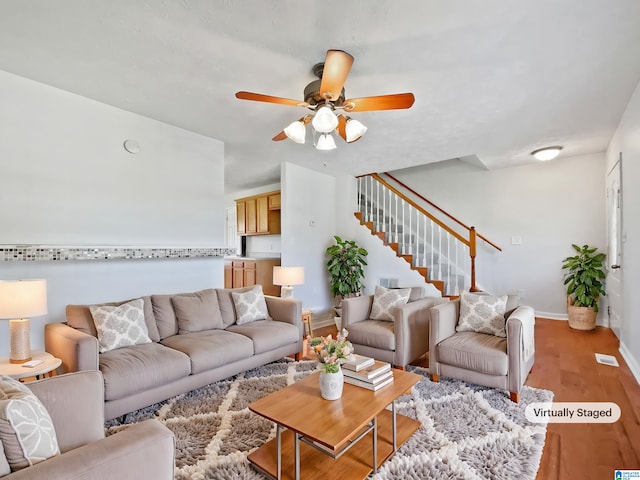 3 Holt Ave, Birmingham, AL 35214 - living room featuring ceiling fan, light wood finished floors, baseboards, and stairway