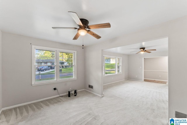 spare room with visible vents, ceiling fan, and a healthy amount of sunlight