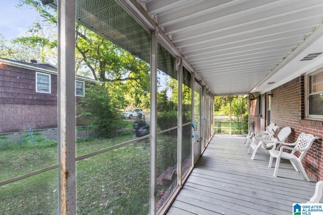 wooden terrace with fence and a sunroom