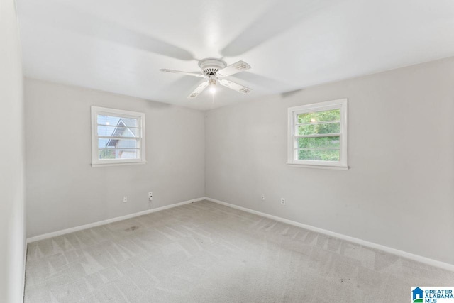 unfurnished room with light carpet, baseboards, and ceiling fan