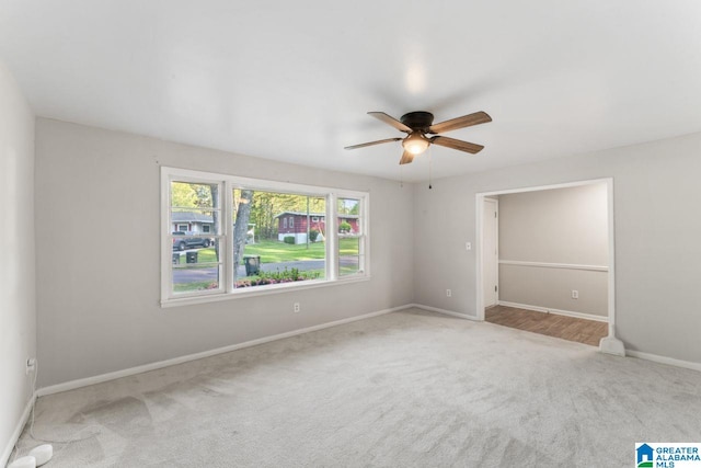 unfurnished bedroom featuring baseboards, a ceiling fan, and carpet