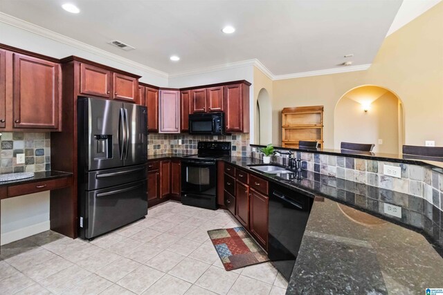 kitchen featuring arched walkways, visible vents, a sink, and black appliances
