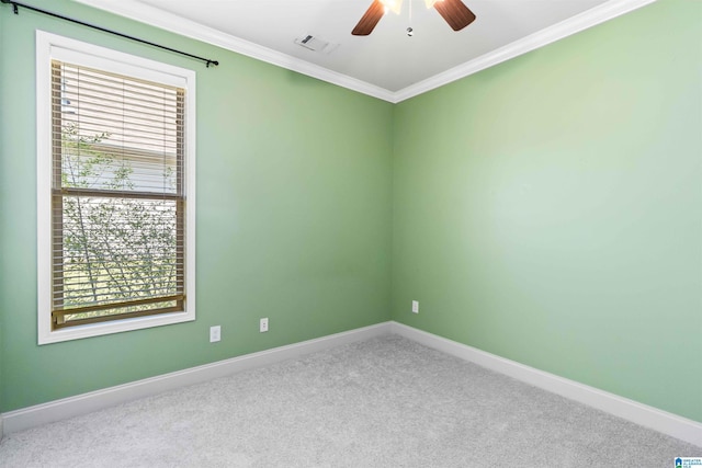 spare room with ornamental molding, visible vents, baseboards, and carpet flooring