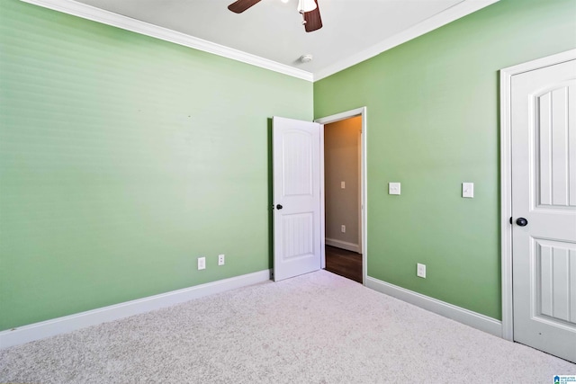 unfurnished bedroom with ornamental molding, carpet floors, baseboards, and a ceiling fan