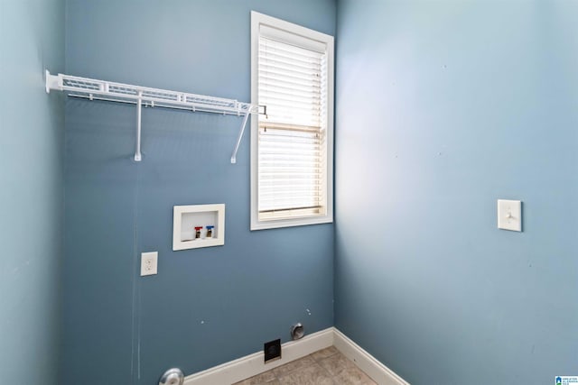 washroom featuring laundry area, washer hookup, baseboards, and tile patterned flooring
