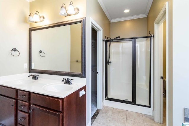 full bathroom with a shower stall, tile patterned flooring, a sink, and crown molding