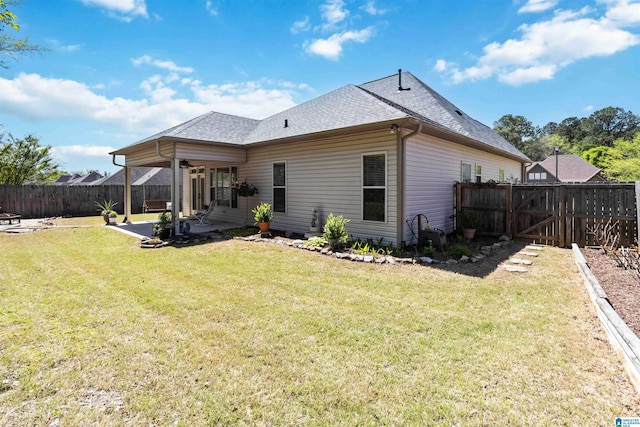back of property with a fenced backyard, a lawn, a patio, a gate, and a shingled roof