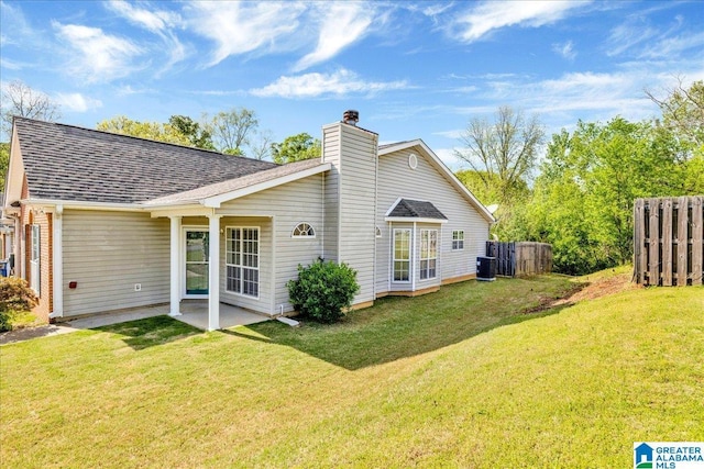 back of house with a patio, a chimney, cooling unit, a yard, and fence