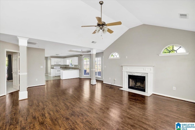 unfurnished living room with ceiling fan, a fireplace, dark wood-style floors, and visible vents