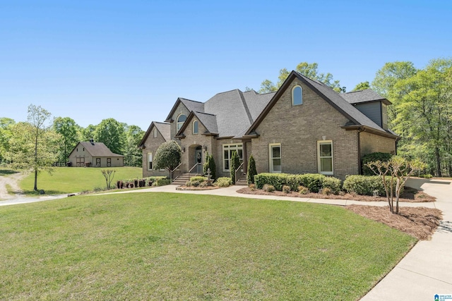 view of front of house with brick siding and a front yard