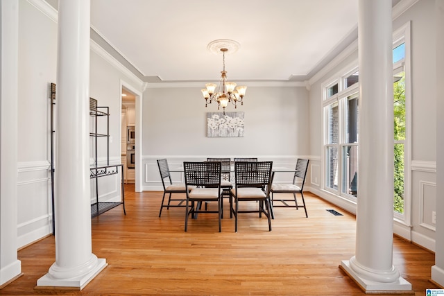 dining room with crown molding, visible vents, and plenty of natural light
