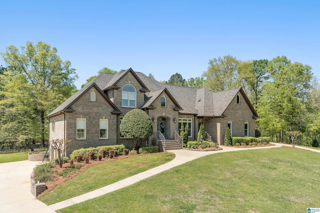 craftsman-style house featuring brick siding and a front yard