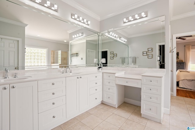 ensuite bathroom with tile patterned floors, a sink, and a shower with door