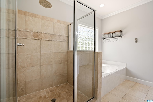bathroom with tile patterned floors, ornamental molding, baseboards, a garden tub, and a stall shower