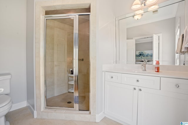 bathroom with a shower stall, vanity, baseboards, toilet, and visible vents