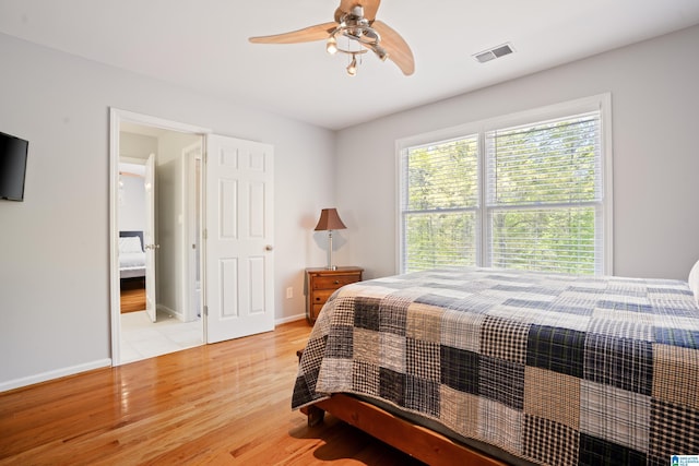bedroom with baseboards, visible vents, light wood-style floors, and ceiling fan