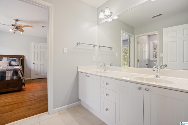 bathroom featuring baseboards, a sink, and visible vents