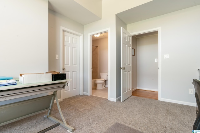 interior space featuring baseboards and connected bathroom