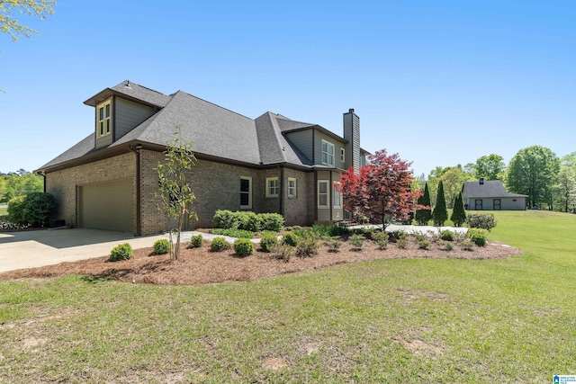 view of property exterior featuring a lawn, a chimney, driveway, a shingled roof, and brick siding