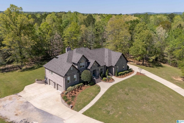 bird's eye view featuring a wooded view