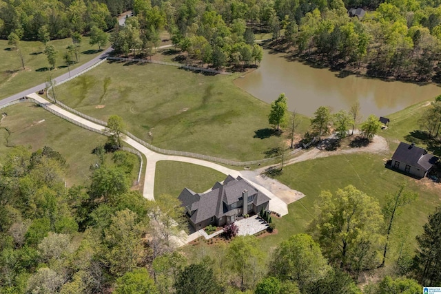 aerial view featuring a forest view and a water view