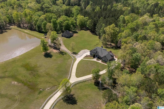drone / aerial view with a view of trees and a water view