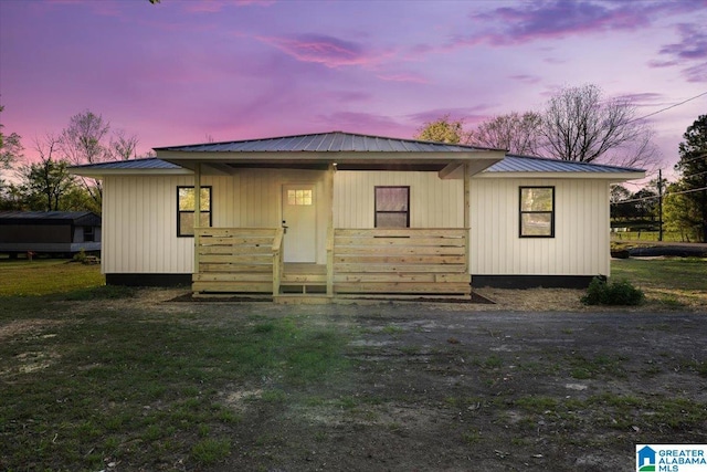 rear view of property with metal roof