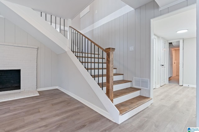 686 Ridge Top Cir, Birmingham, AL 35206 - stairs featuring visible vents, baseboards, a brick fireplace, and wood finished floors