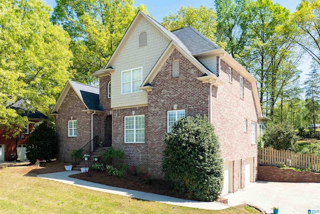 7717 Clayton Cove Pkwy, Clay, AL 35126 - view of front of house featuring a front yard, an attached garage, fence, concrete driveway, and brick siding