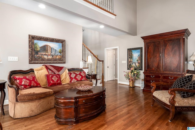 7717 Clayton Cove Pkwy, Clay, AL 35126 - living area featuring wood finished floors, a towering ceiling, baseboards, and stairs