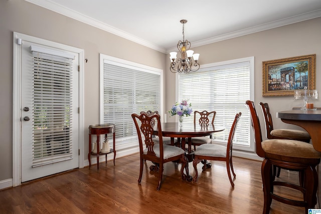 7717 Clayton Cove Pkwy, Clay, AL 35126 - dining space with ornamental molding, plenty of natural light, a chandelier, and dark wood-style floors